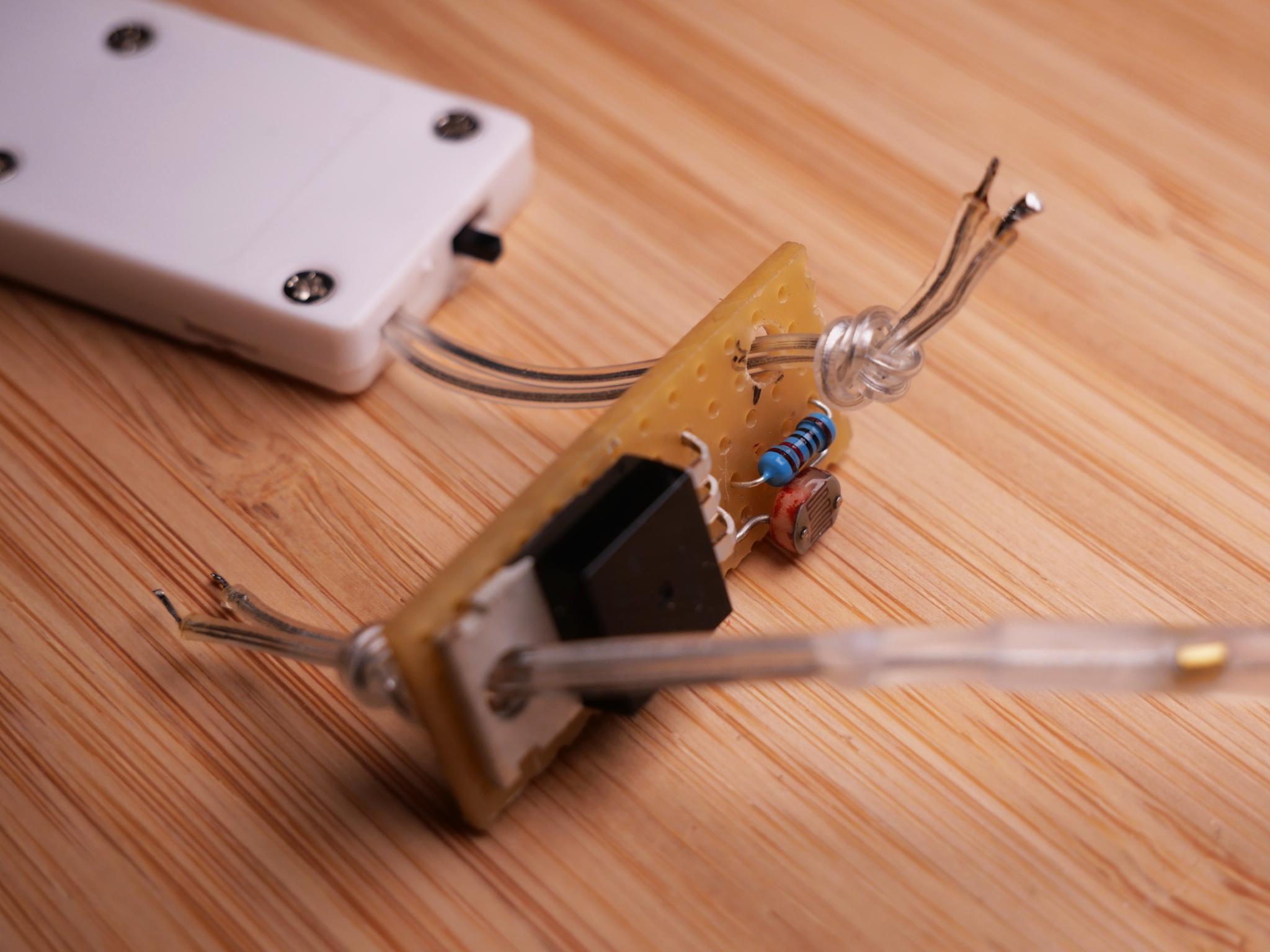 Step 7: Pull the wire through the holes, fix them in place with a knot as strain relieve