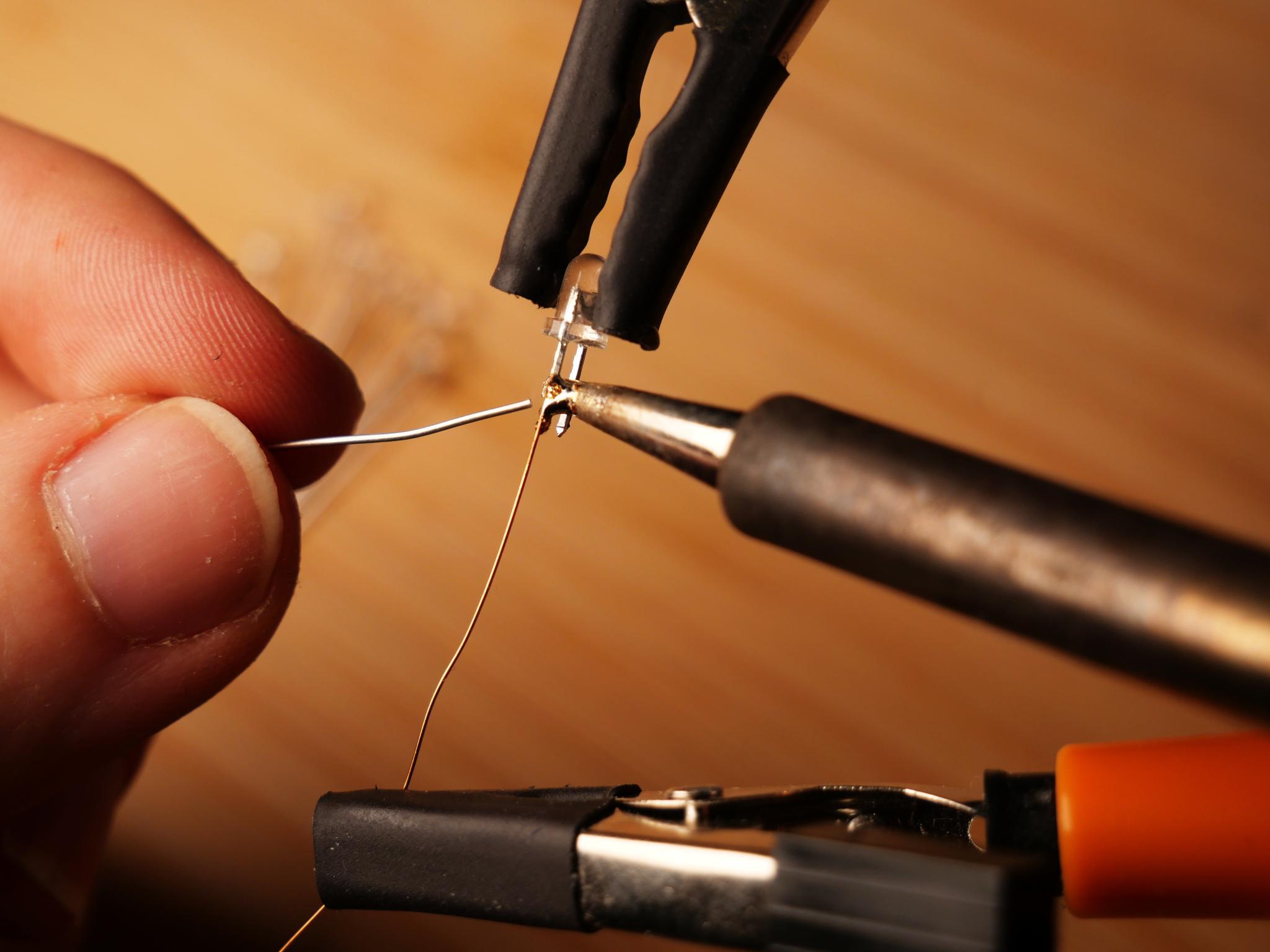 Soldering the copper wire to the LEDs
